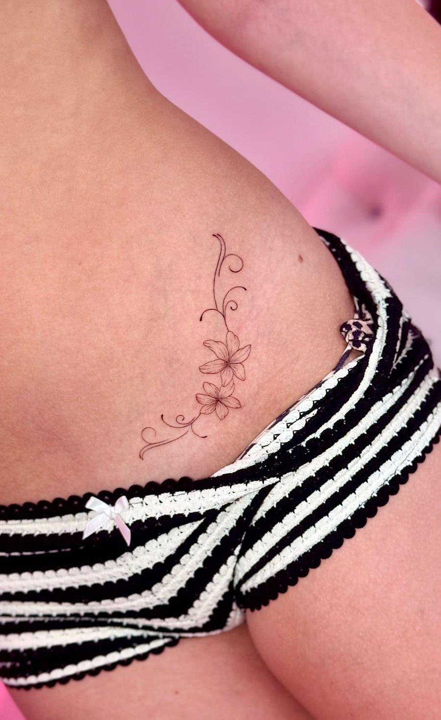 Fine line floral tattoo LaLokura